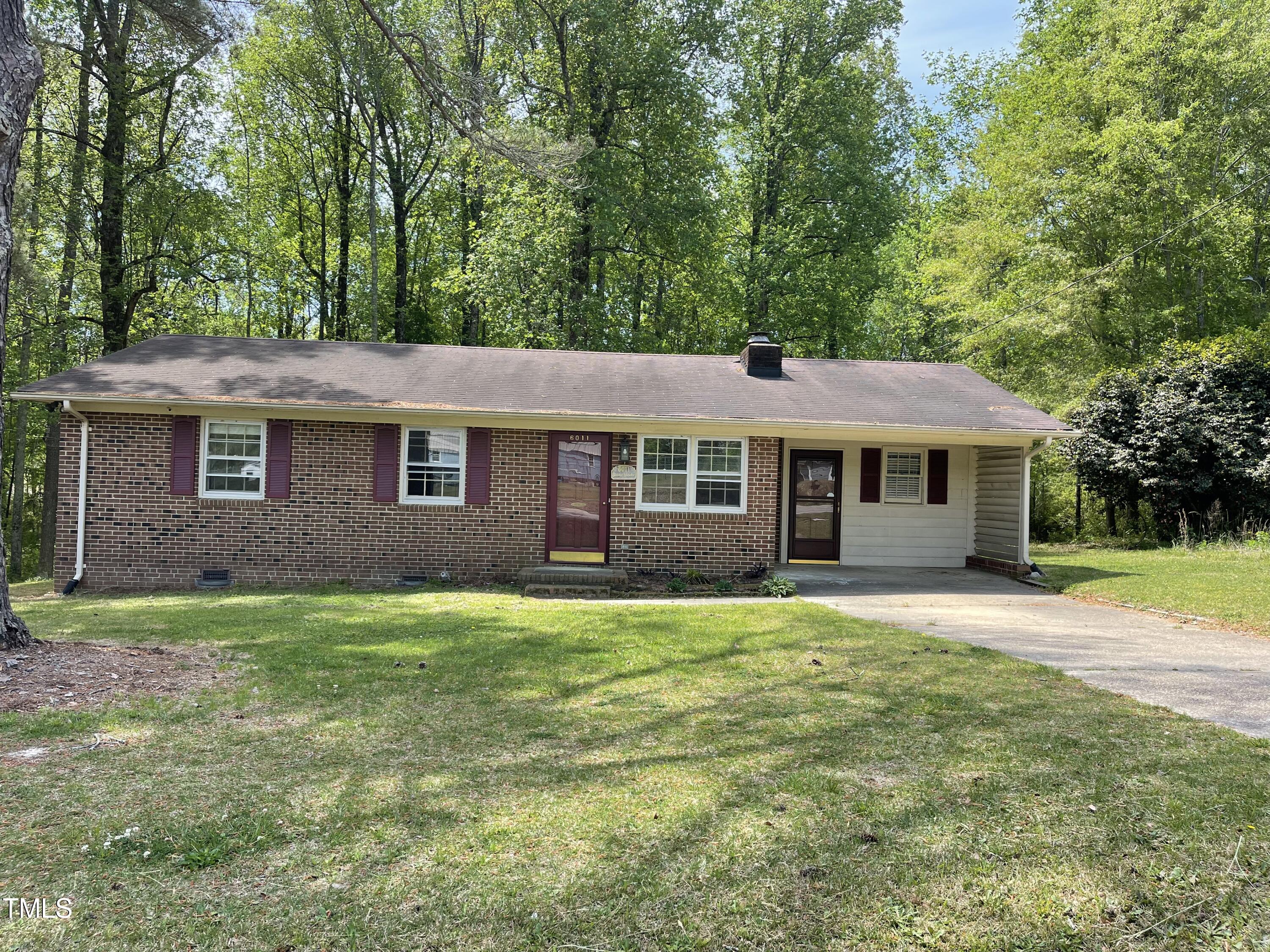 6011 Benson Hardee Road Benson, NC 27504 - Photo 1 of 49 a front view of a house with a garden