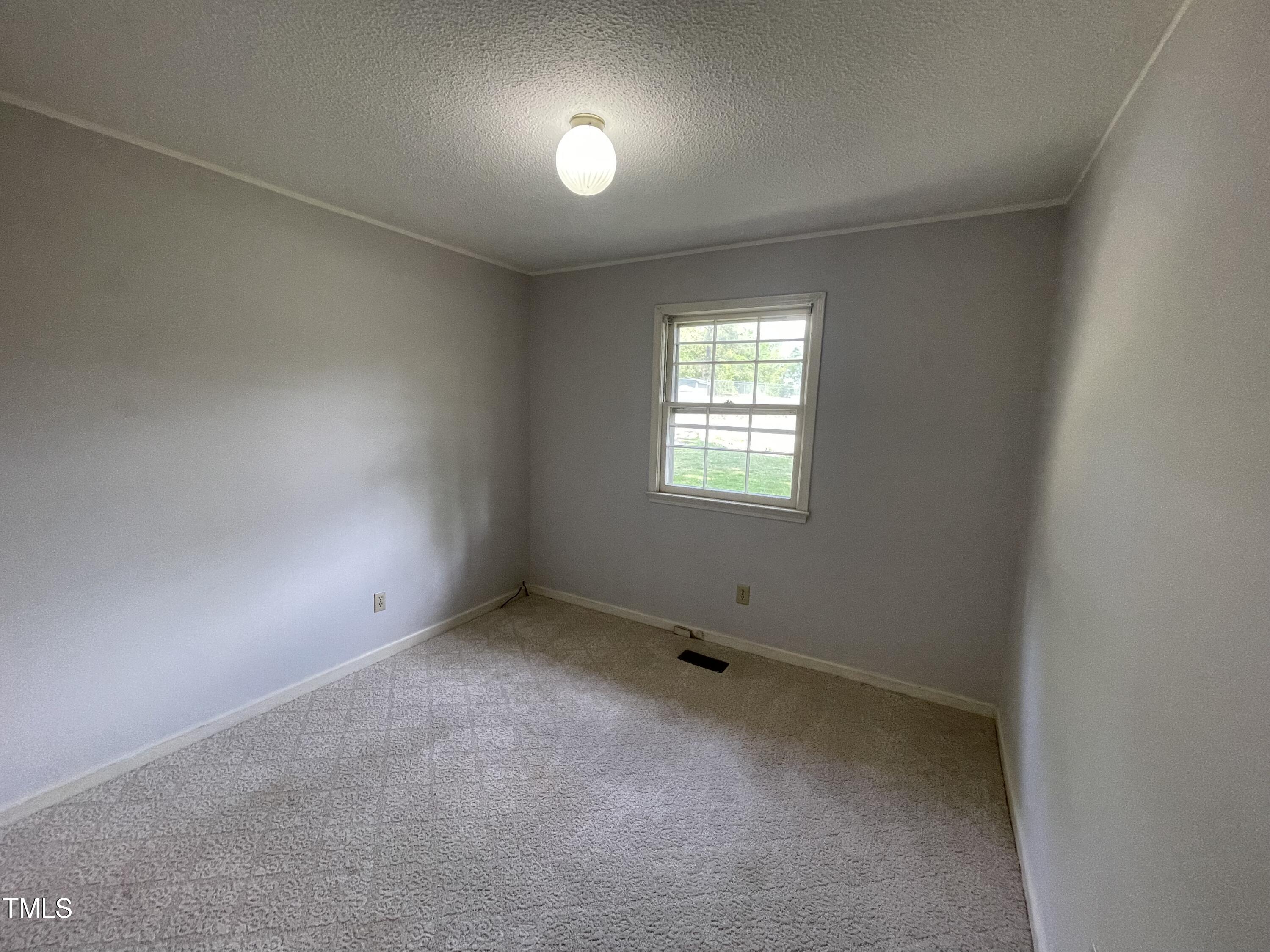 6011 Benson Hardee Road Benson, NC 27504 - Photo 33 of 49 an empty room with a window