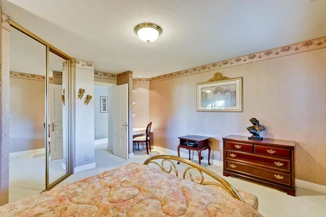 a spacious bedroom with a bed and a large window