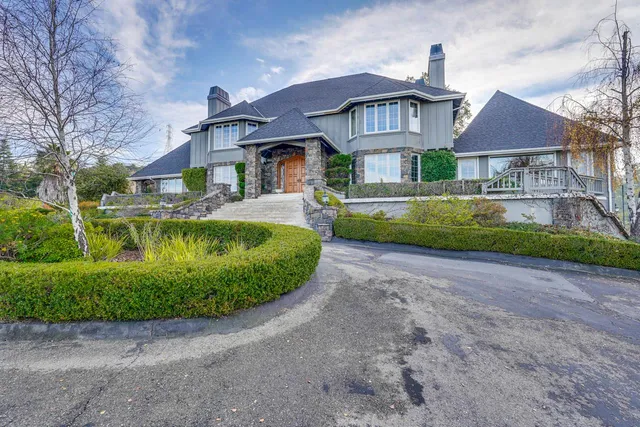 a front view of a house with a garden and deck