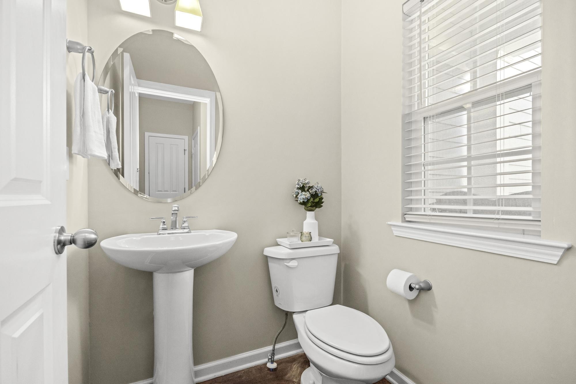 112 Bergen Drive Spring Hill, TN 37174 - Photo 21 of 37 a bathroom with a toilet sink and mirror