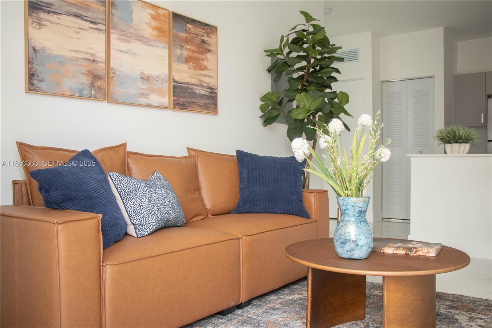 1451 West 29th Street, Unit 206 Hialeah, FL 33012 - Photo 15 of 19 a living room with furniture a potted plant and a lamp