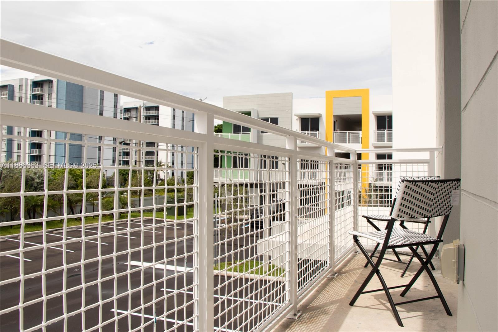 1451 West 29th Street, Unit 206 Hialeah, FL 33012 - Photo 19 of 19 a view of a large building from a balcony