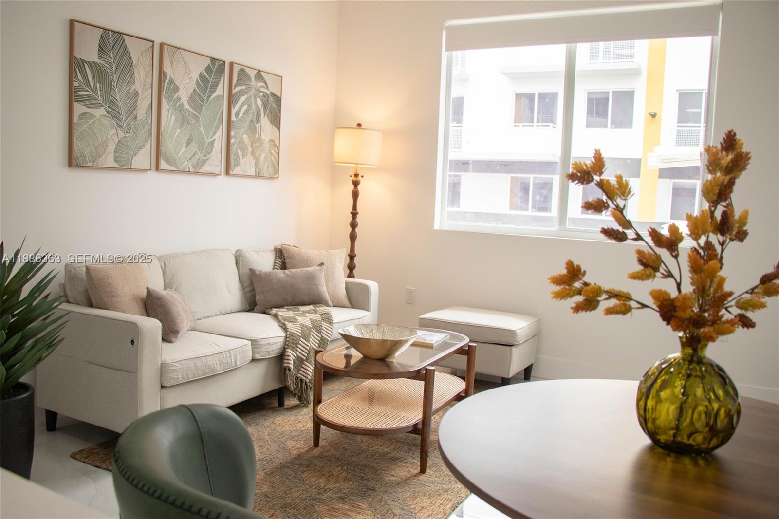 1451 West 29th Street, Unit 206 Hialeah, FL 33012 - Photo 10 of 19 a living room with furniture and a potted plant