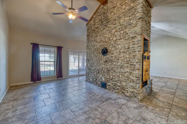 wooden floor in an empty room with a fireplace