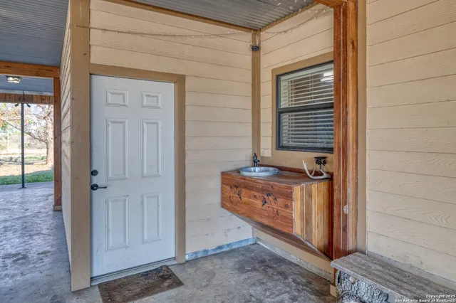 a room with a sink cabinets and utility