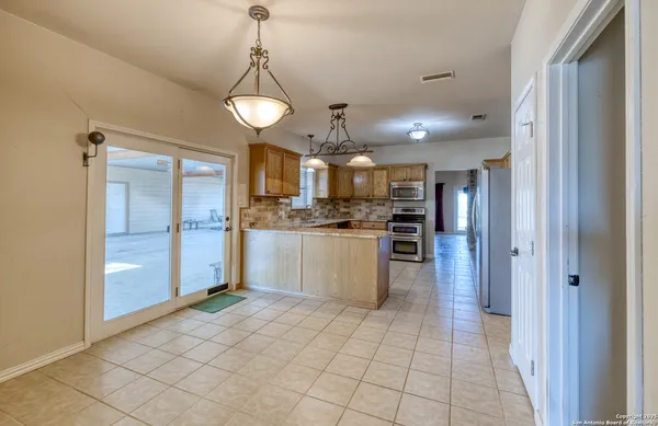a kitchen with stainless steel appliances granite countertop a sink counter space cabinets and a stove