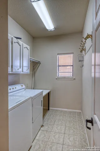 a kitchen with cabinets appliances a sink and a window