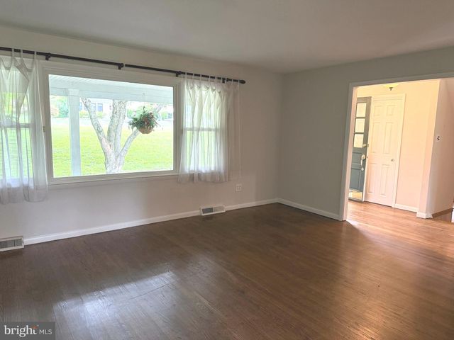 a kitchen with stainless steel appliances kitchen island granite countertop a refrigerator a stove and a sink