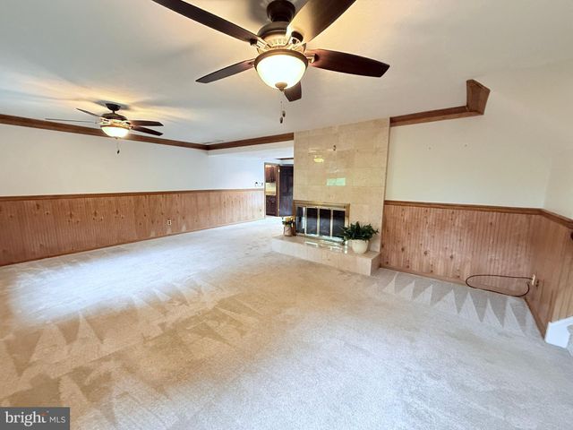 a room with pool table and windows