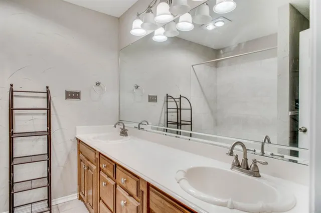 a bathroom with a double vanity sink and a mirror