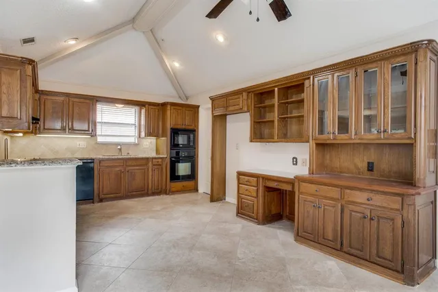 a kitchen with stainless steel appliances granite countertop a stove sink and cabinets