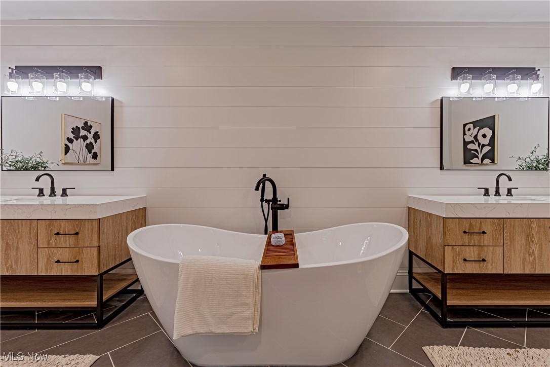 1572 Bell Road Chagrin Falls, OH 44022 - Photo 14 of 36 Bathroom featuring vanity, a bathtub, and tile patterned floors