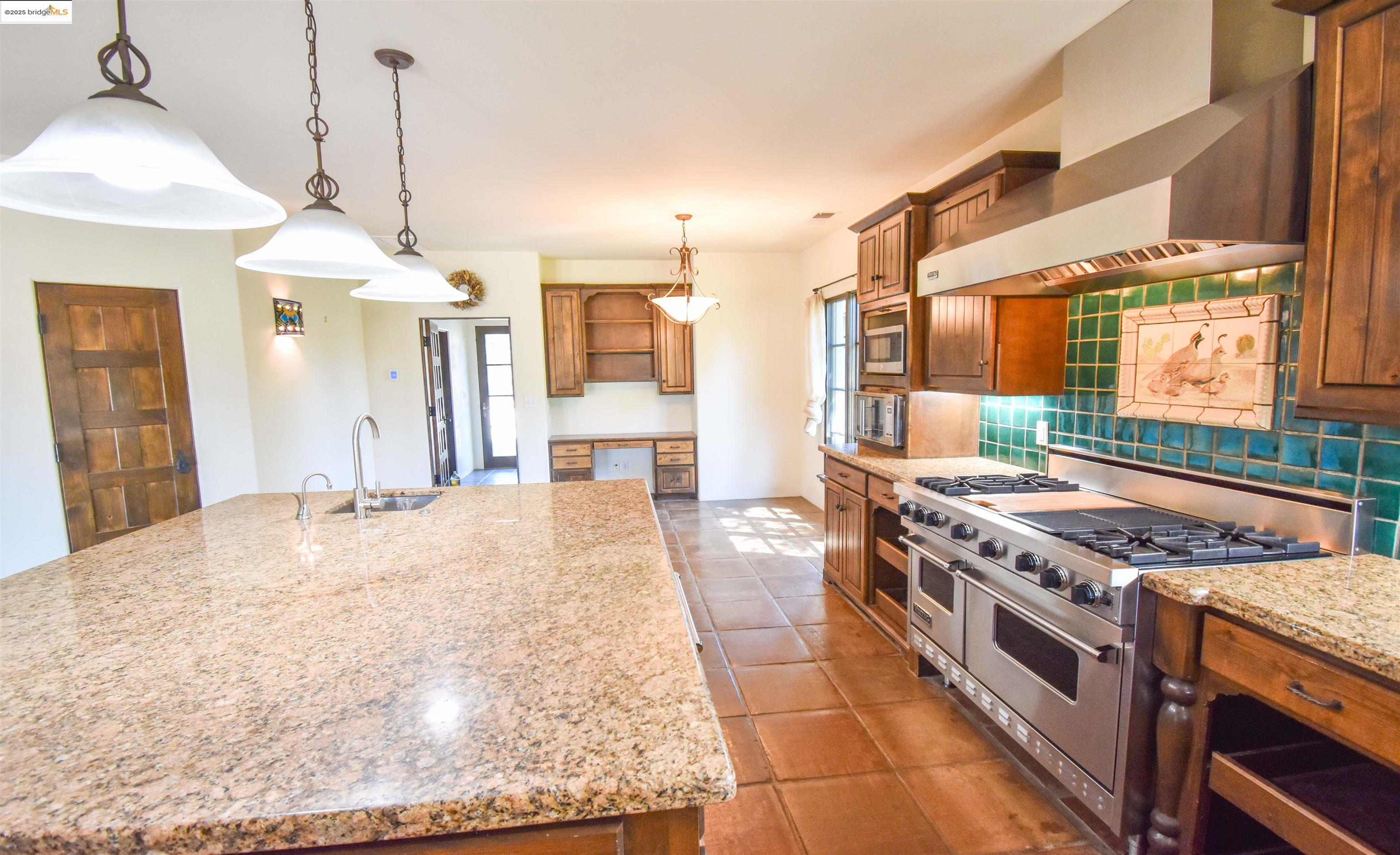 26255 Powell Ranch Road Sonora, CA 95370 - Photo 11 of 48 a kitchen with stainless steel appliances granite countertop a stove a sink and a refrigerator