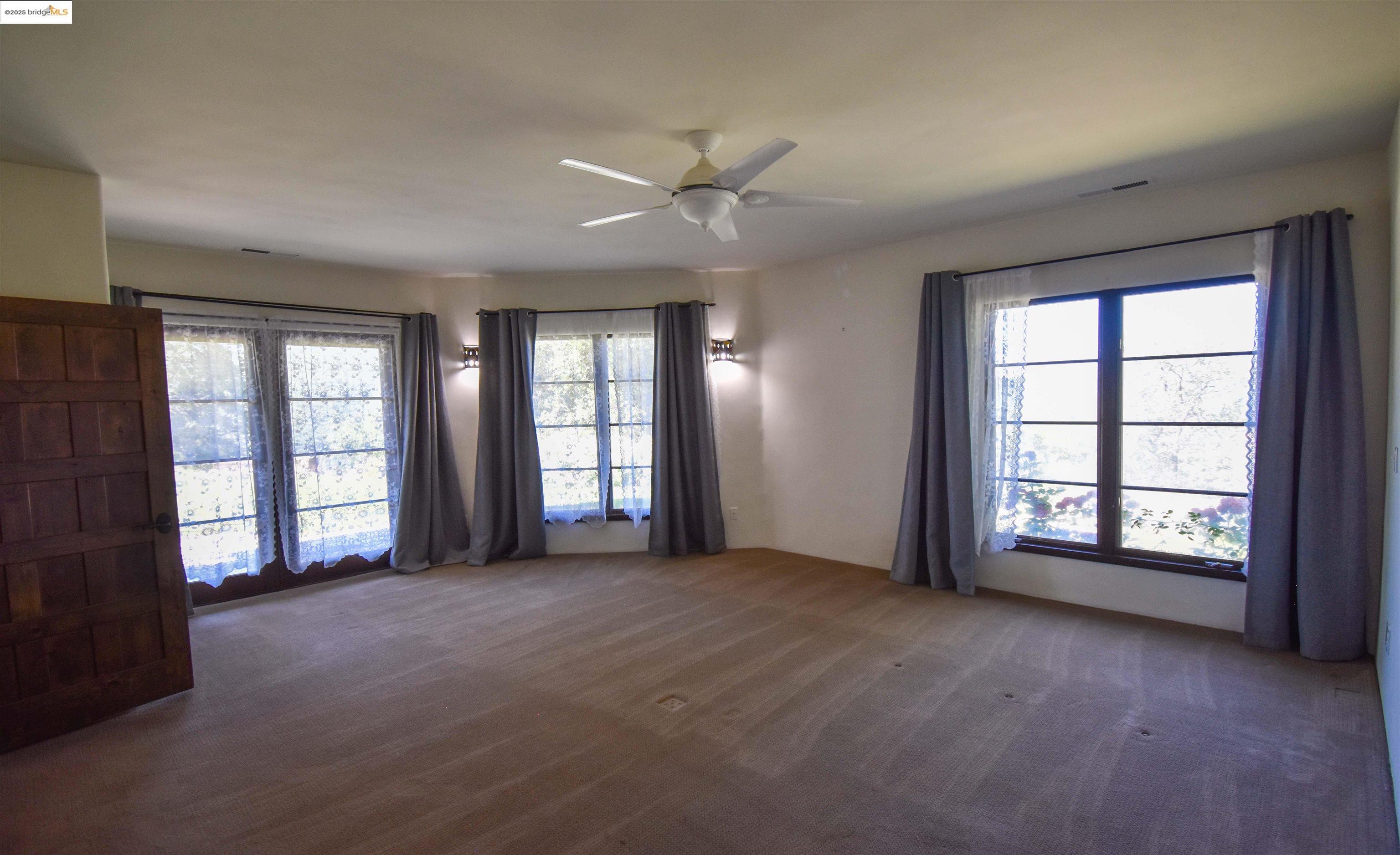 26255 Powell Ranch Road Sonora, CA 95370 - Photo 13 of 48 a view of an empty room with a window and a kitchen