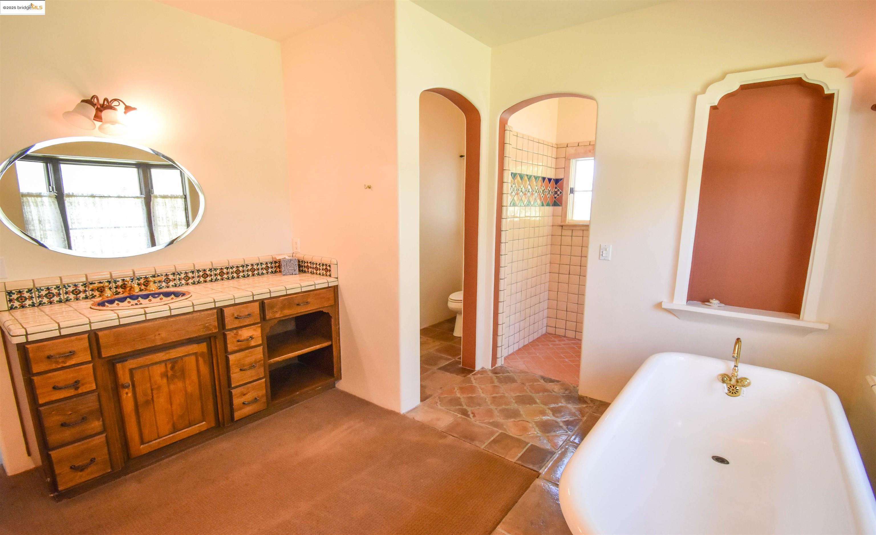 26255 Powell Ranch Road Sonora, CA 95370 - Photo 14 of 48 a spacious bathroom with a tub sink and mirror