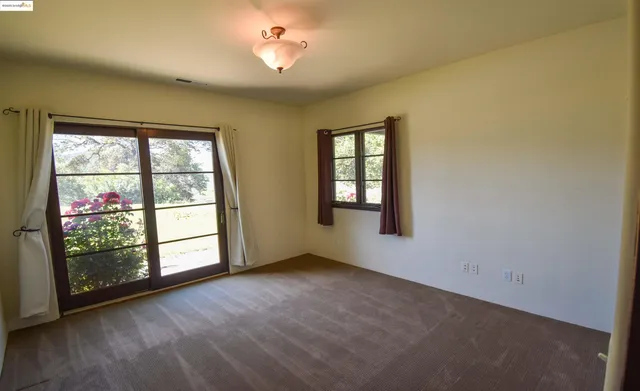 a view of a hallway with closet and wooden floor