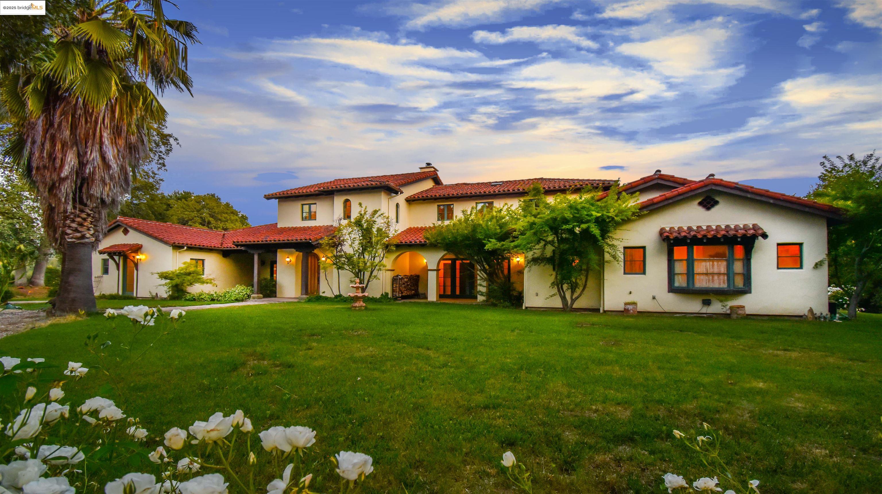 26255 Powell Ranch Road Sonora, CA 95370 - Photo 2 of 48 a front view of a house with a yard