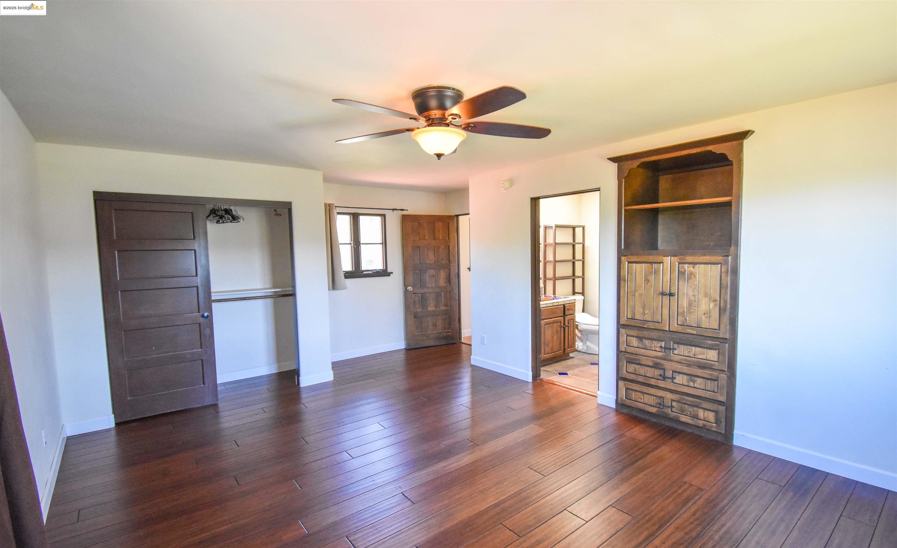 26255 Powell Ranch Road Sonora, CA 95370 - Photo 27 of 48 a view of an empty room with window and wooden floor