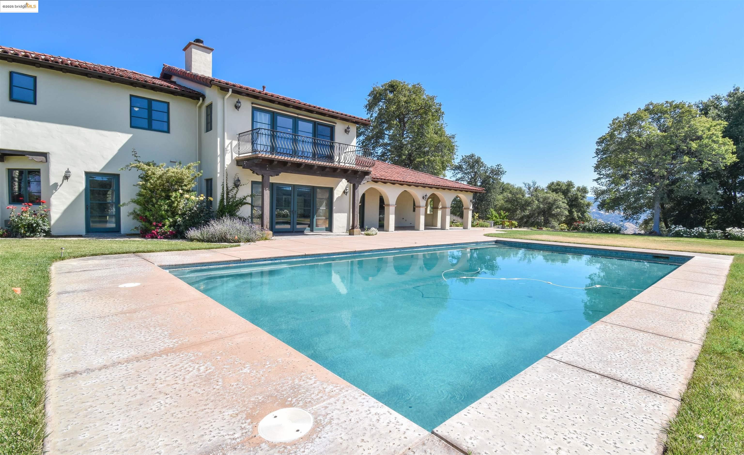 26255 Powell Ranch Road Sonora, CA 95370 - Photo 33 of 48 a view of a house with a swimming pool