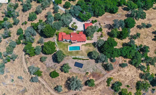 an aerial view of a house with a yard and lake view