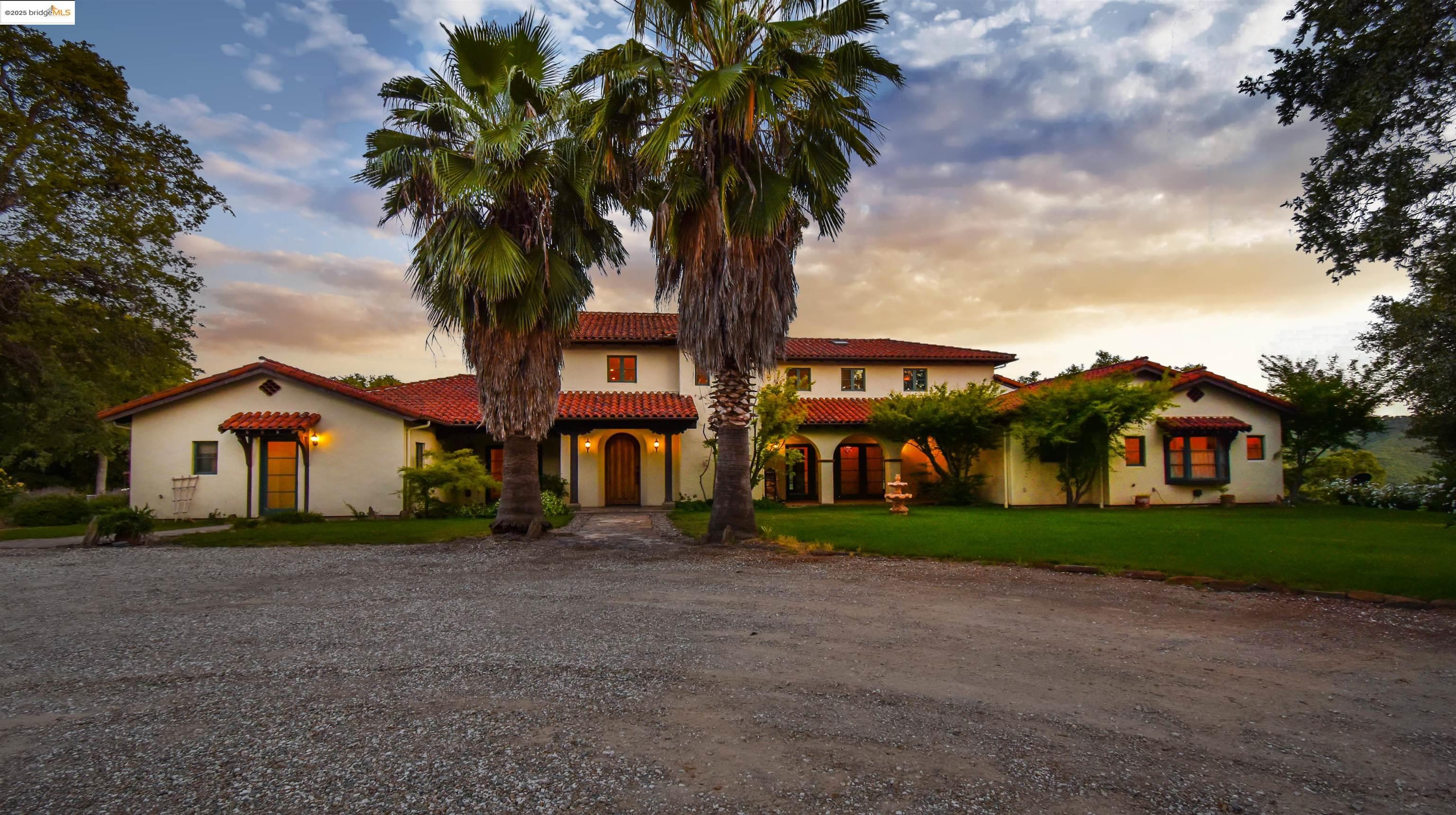 26255 Powell Ranch Road Sonora, CA 95370 - Photo 5 of 48 a front view of a house with a garden and trees