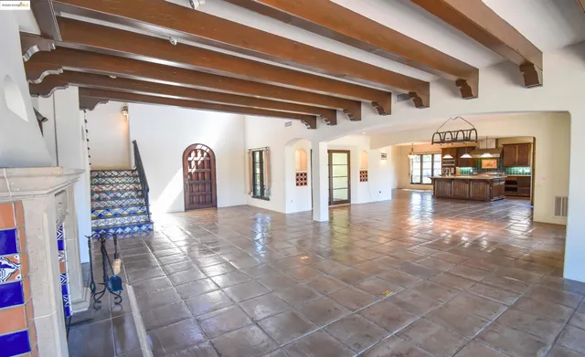 a open kitchen with stainless steel appliances granite countertop a stove and a view of living room