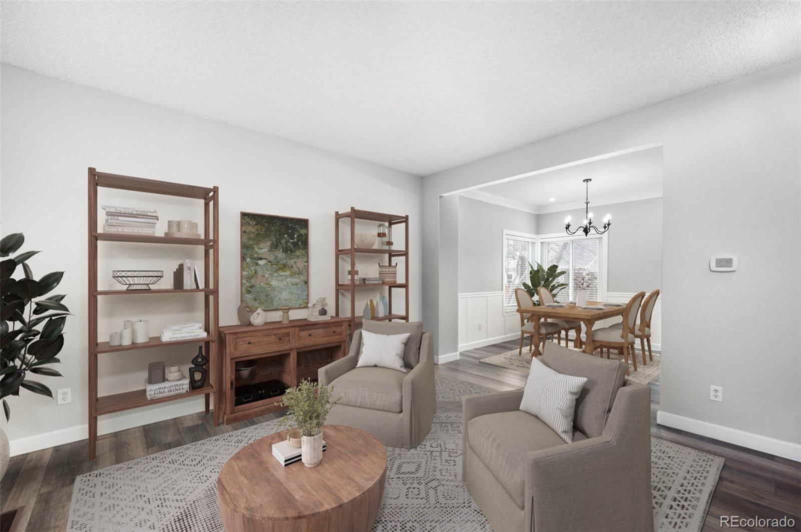 a living room with furniture and a potted plant