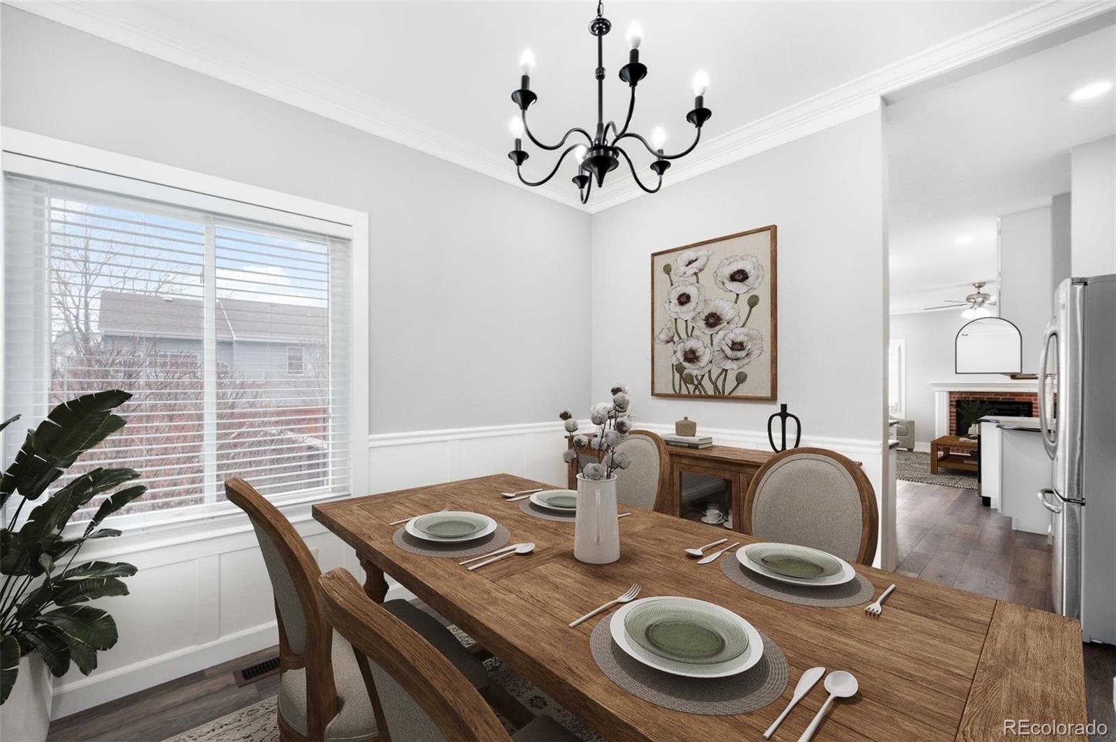 3618 West Rosewalk Circle Highlands Ranch, CO 80129 - Photo 11 of 45 a dining room with wooden floor and chandelier