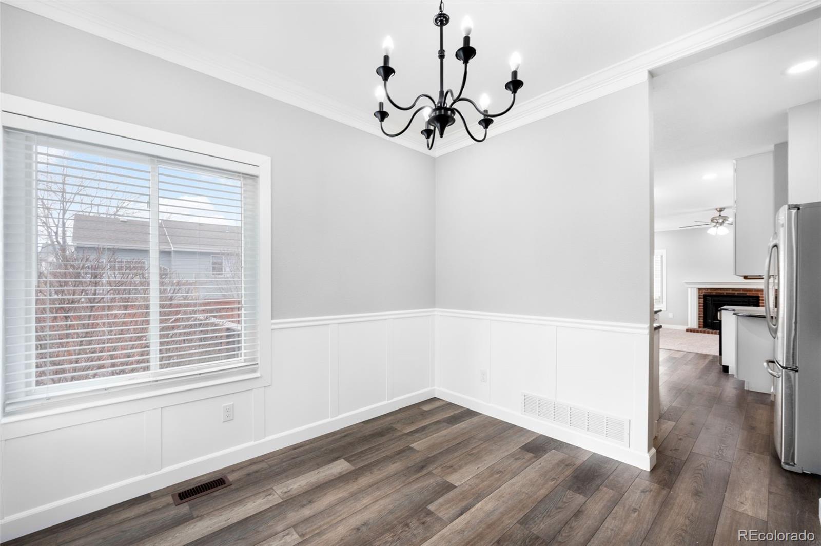 3618 West Rosewalk Circle Highlands Ranch, CO 80129 - Photo 12 of 45 a view of a room with wooden floor and a window