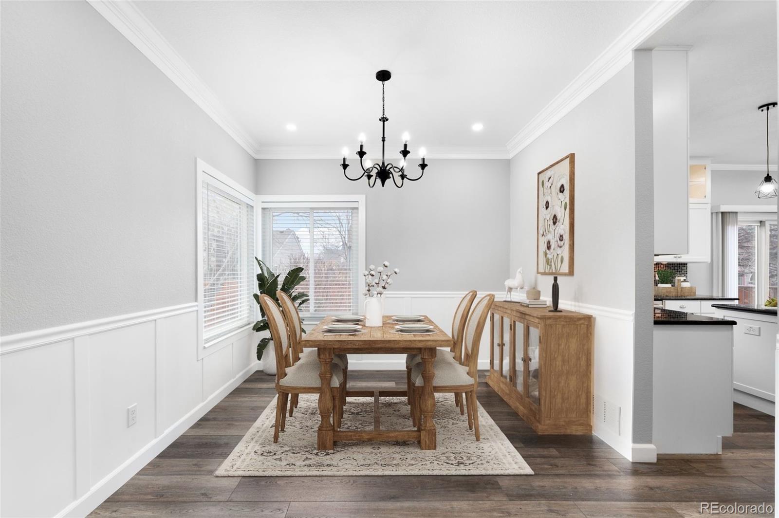 3618 West Rosewalk Circle Highlands Ranch, CO 80129 - Photo 13 of 45 a dining room with furniture a chandelier and wooden floor