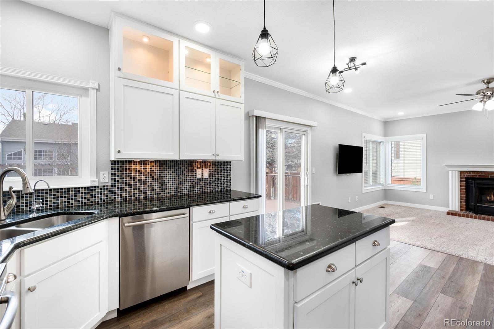 3618 West Rosewalk Circle Highlands Ranch, CO 80129 - Photo 15 of 45 a kitchen with granite countertop a sink cabinets and window