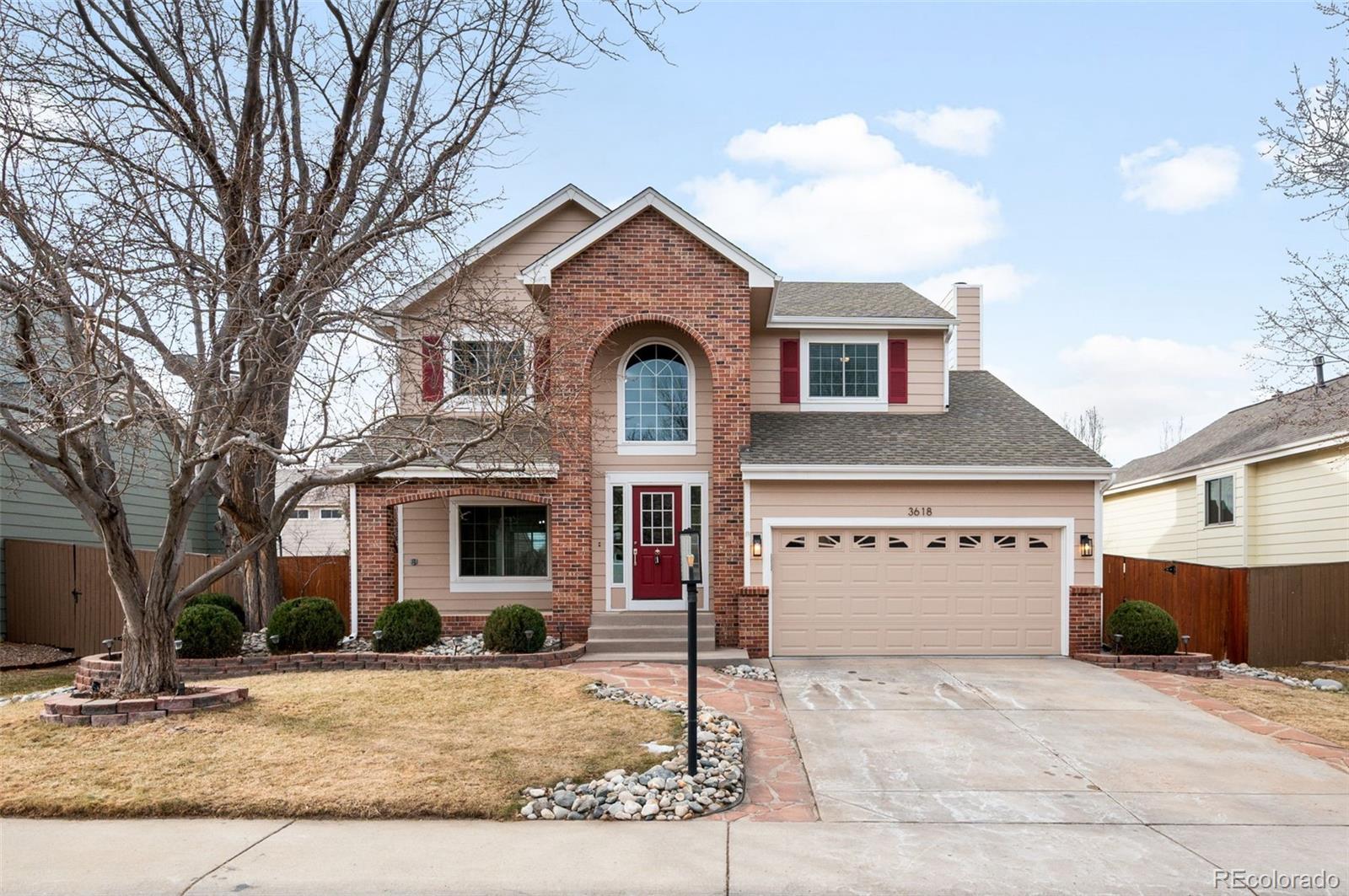 3618 West Rosewalk Circle Highlands Ranch, CO 80129 - Photo 3 of 45 a front view of a house with garden