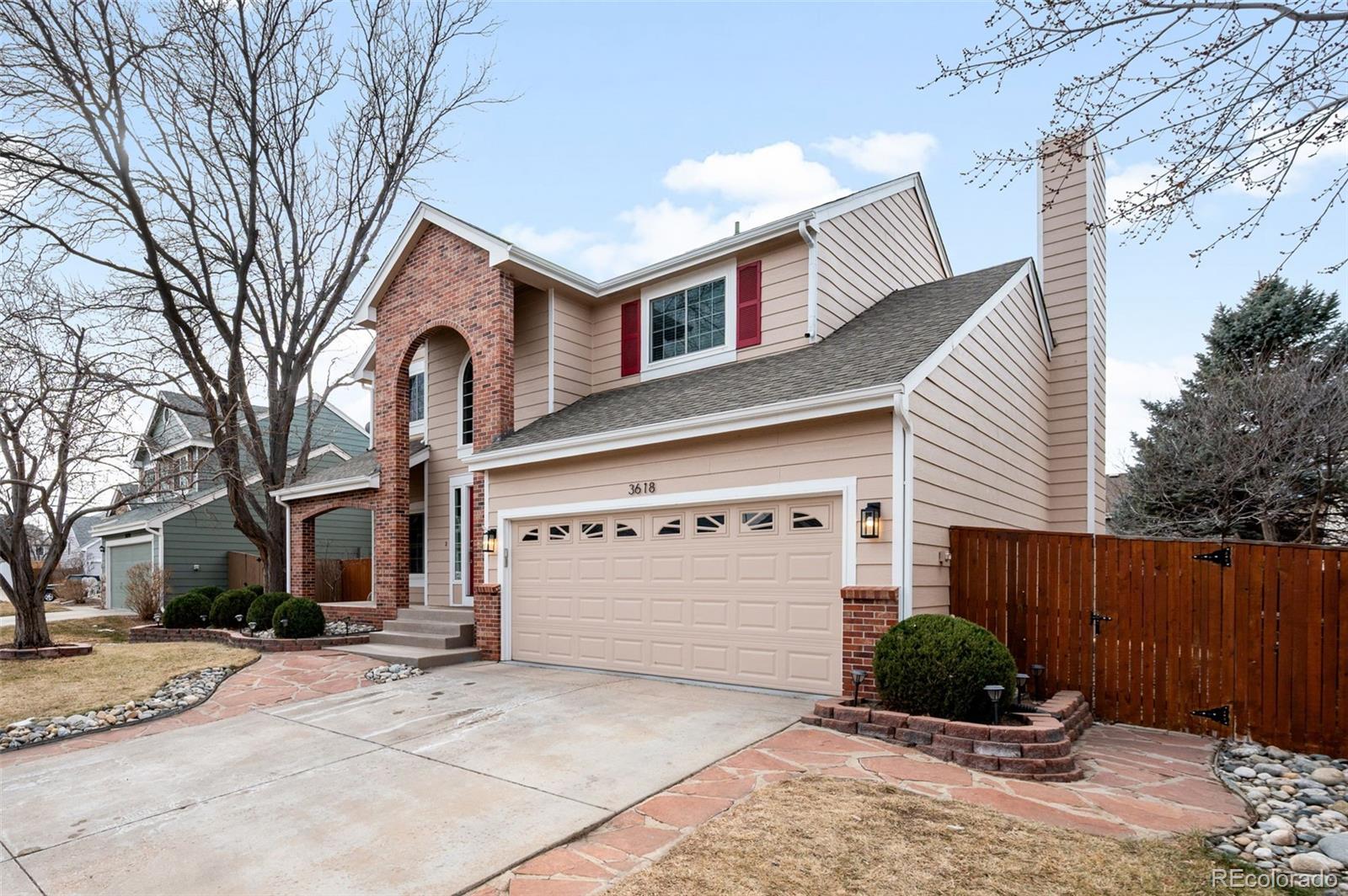 3618 West Rosewalk Circle Highlands Ranch, CO 80129 - Photo 4 of 45 a front view of a house with a yard and garage