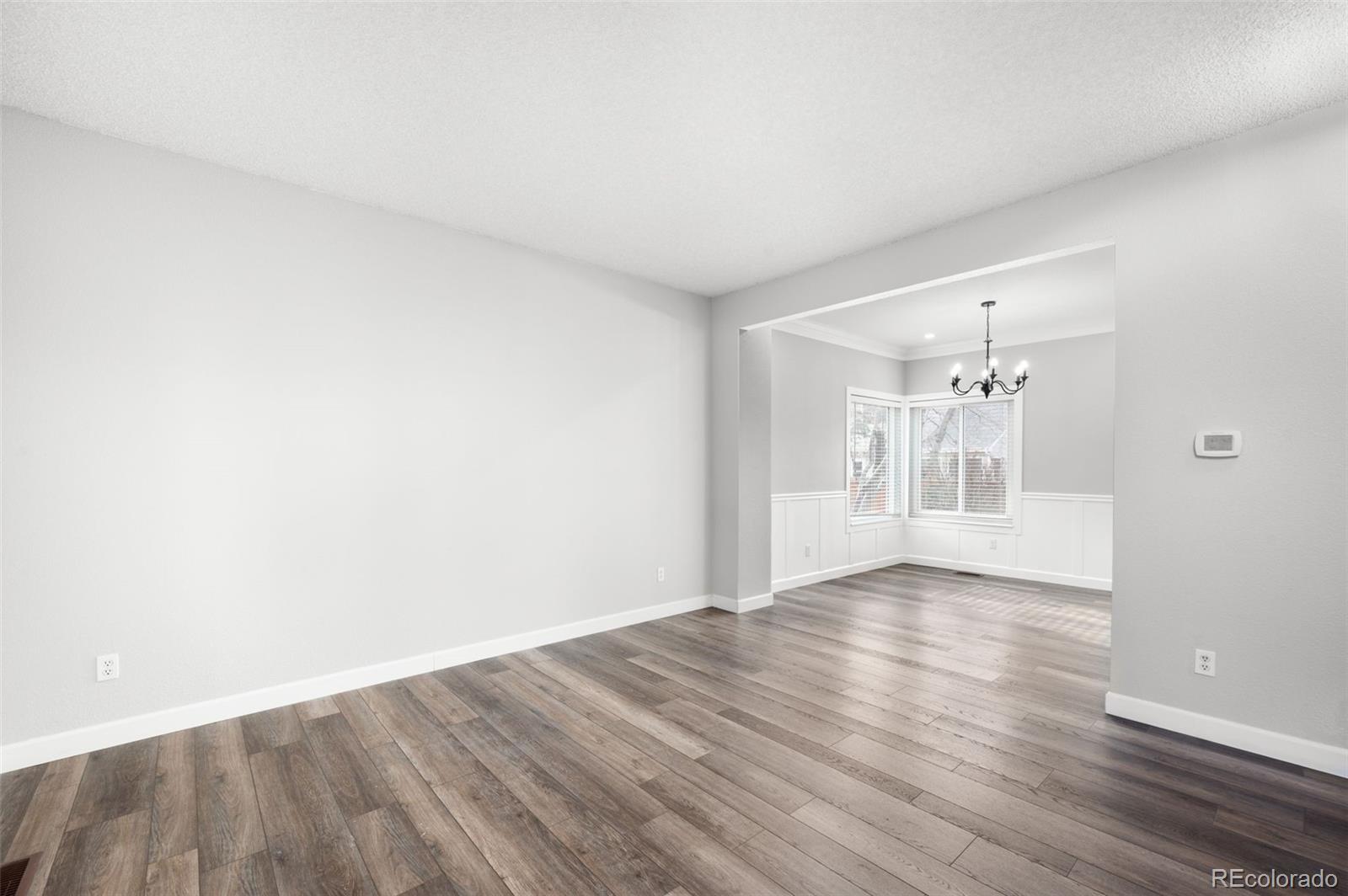 3618 West Rosewalk Circle Highlands Ranch, CO 80129 - Photo 8 of 45 a view of an empty room with wooden floor