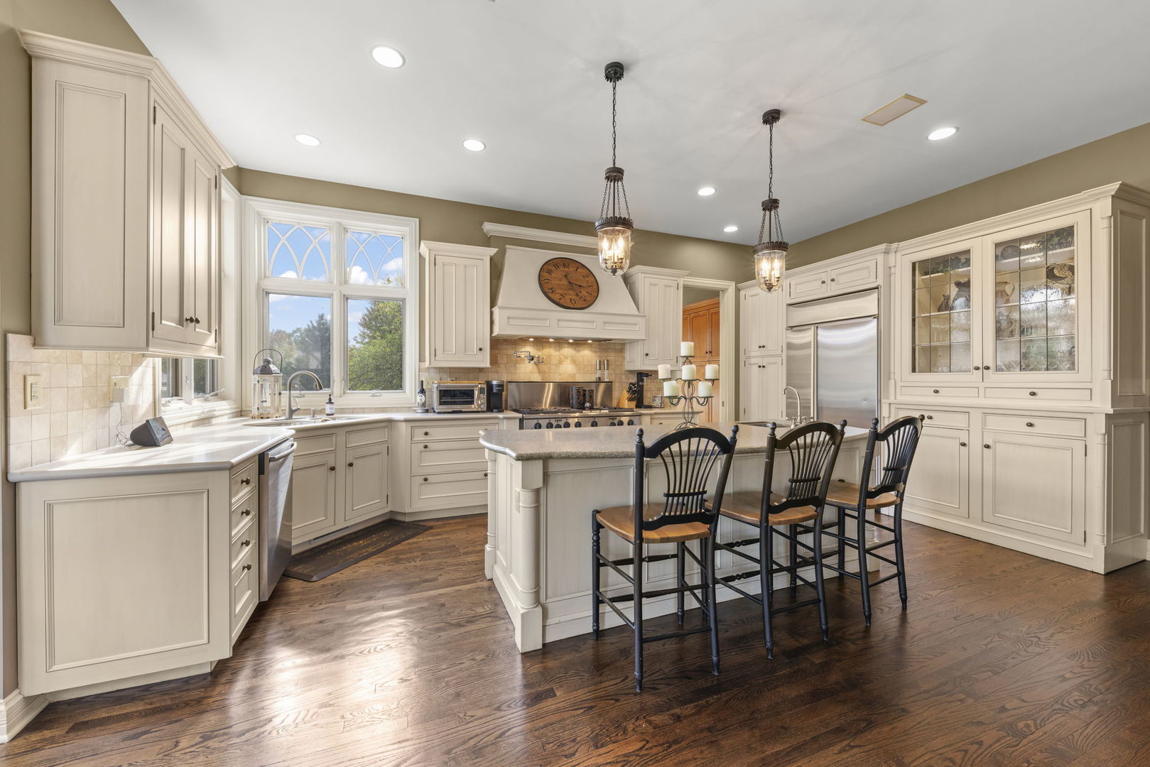 39W114 Fryendall Court Geneva, IL 60134 - Photo 11 of 76 a kitchen with stainless steel appliances a dining table chairs sink and stove top oven