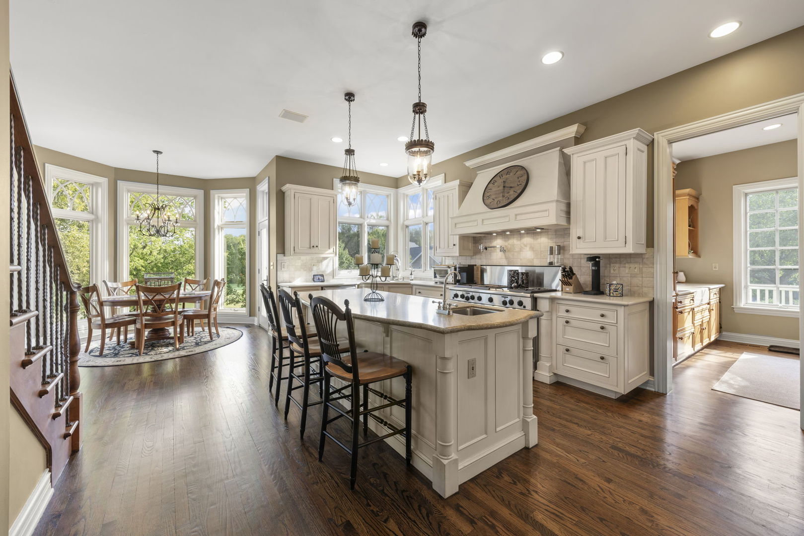 39W114 Fryendall Court Geneva, IL 60134 - Photo 12 of 76 a kitchen with stainless steel appliances granite countertop wooden floor a stove a sink dishwasher and a dining table with wooden floor