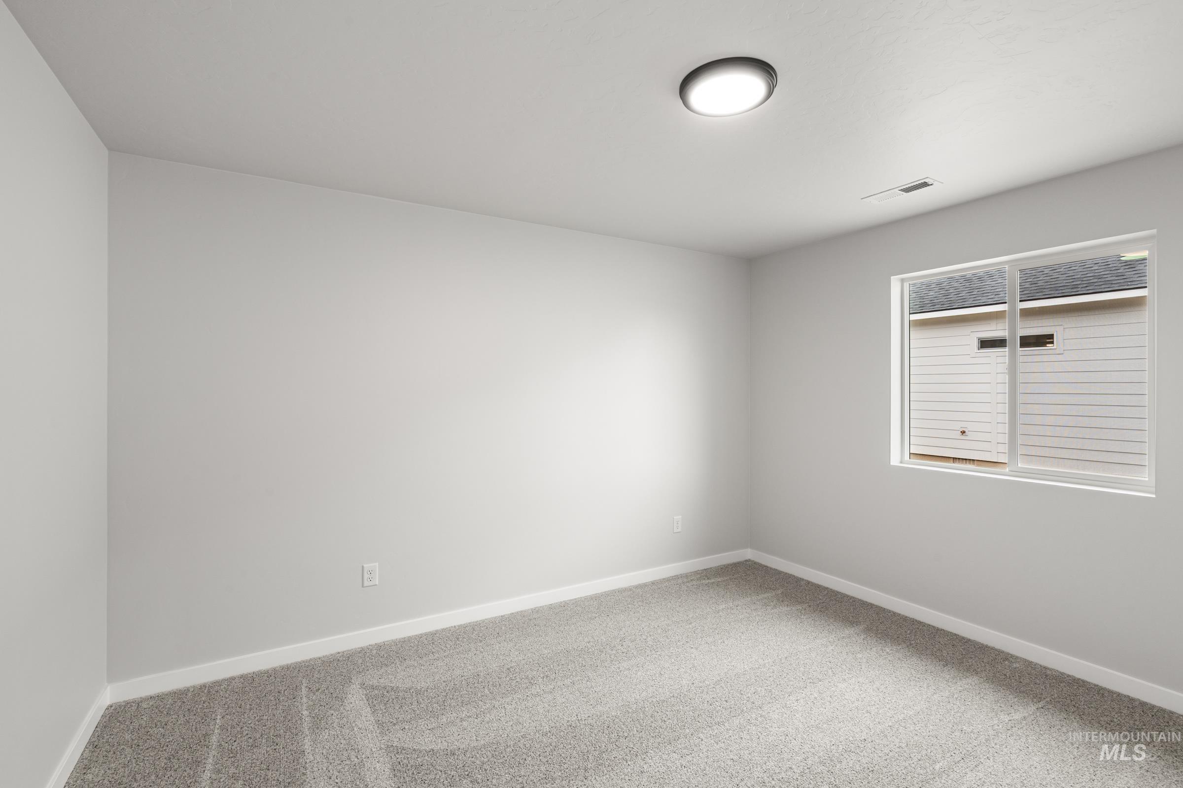511 Hamlow Avenue Middleton, ID 83644 - Photo 12 of 22 Spare room featuring light colored carpet and baseboards