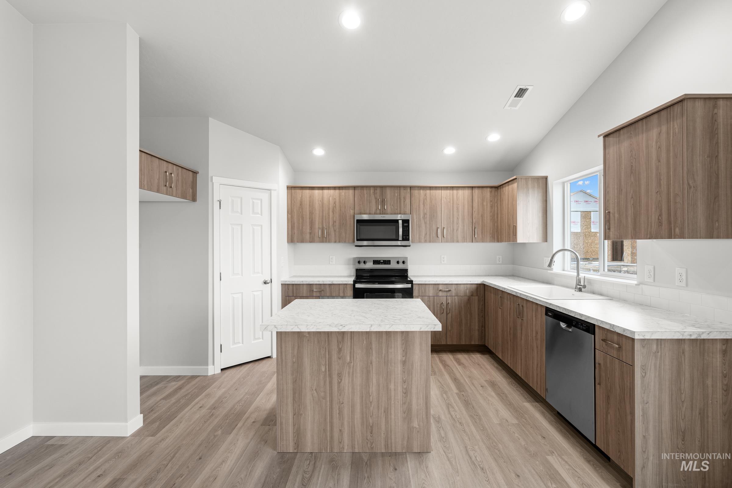 511 Hamlow Avenue Middleton, ID 83644 - Photo 4 of 22 Kitchen featuring a center island, stainless steel appliances, light countertops, modern cabinets, and recessed lighting