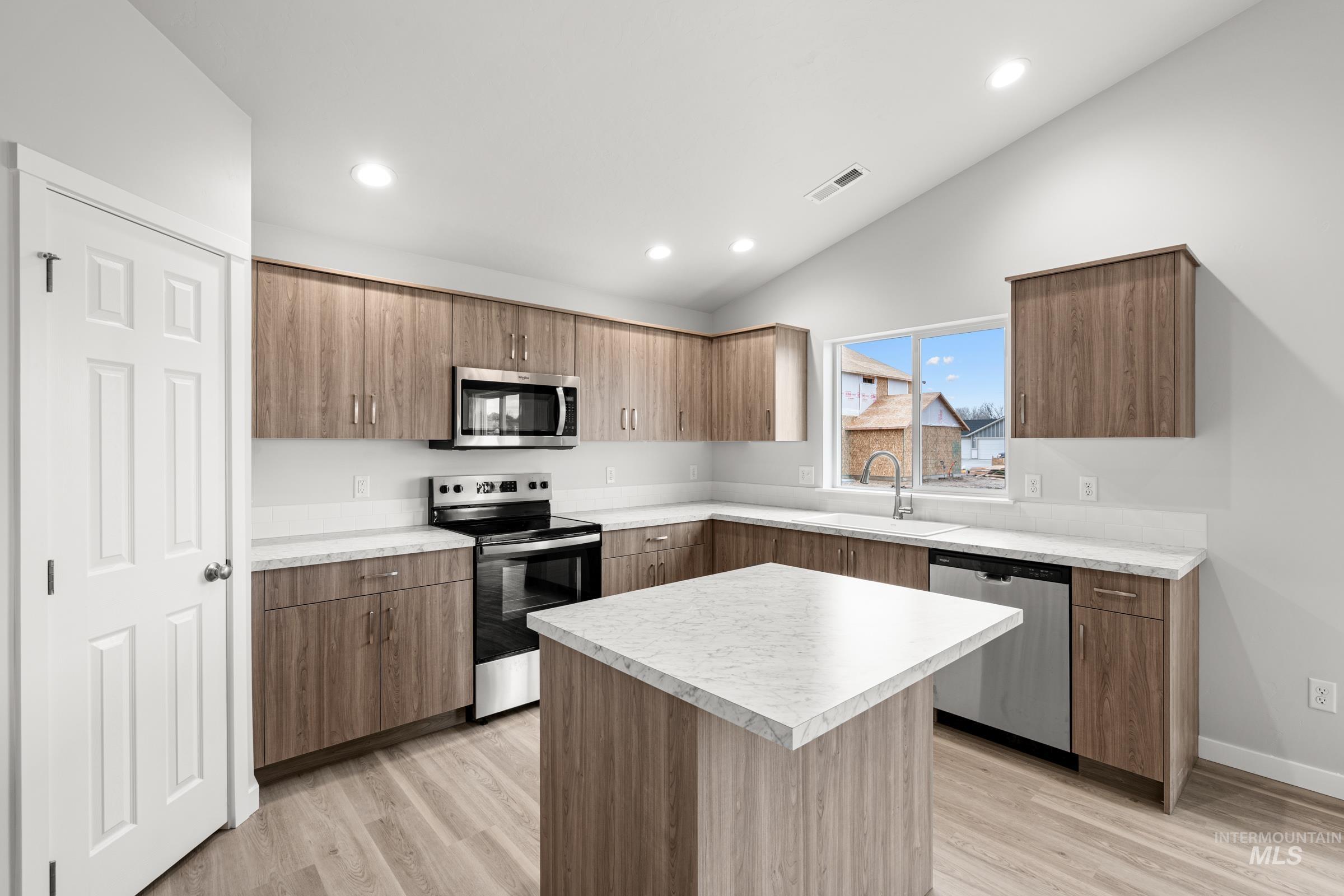 511 Hamlow Avenue Middleton, ID 83644 - Photo 5 of 22 Kitchen featuring stainless steel appliances, a kitchen island, light countertops, light wood-style floors, and modern cabinets