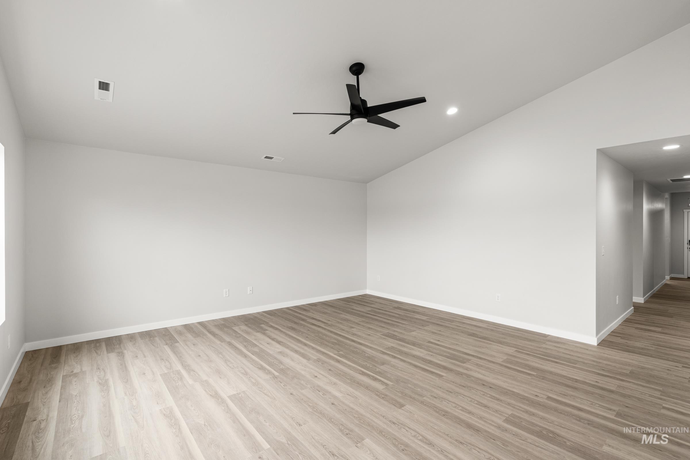 511 Hamlow Avenue Middleton, ID 83644 - Photo 8 of 22 Unfurnished room with lofted ceiling, a ceiling fan, light wood finished floors, and recessed lighting