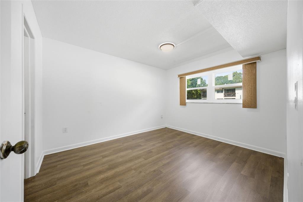 141 Fernery Road, Unit A3 Lakeland, FL 33809 - Photo 14 of 40 an empty room with wooden floor and windows