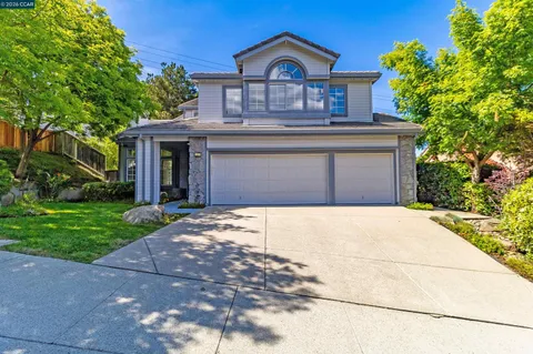 a kitchen with stainless steel appliances kitchen island granite countertop a stove and a wooden floors