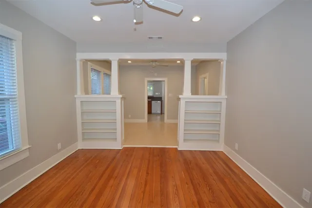 wooden floor in an empty room with a window