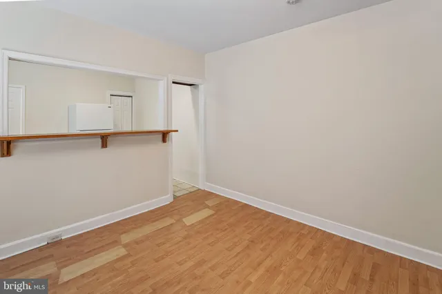 a view of a room with wooden floor