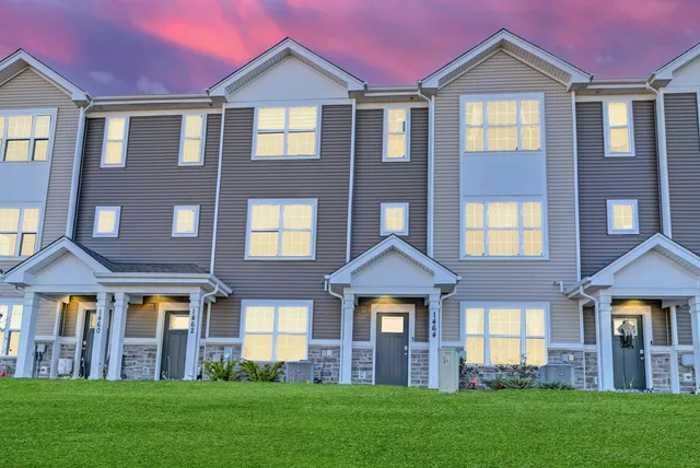 a front view of a house with a yard
