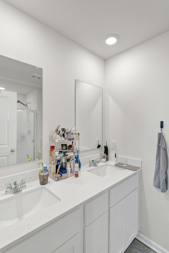 1464 Sequoia Way Hampshire, IL 60140 - Photo 21 of 31 a bathroom with double vanity sinks and a mirror