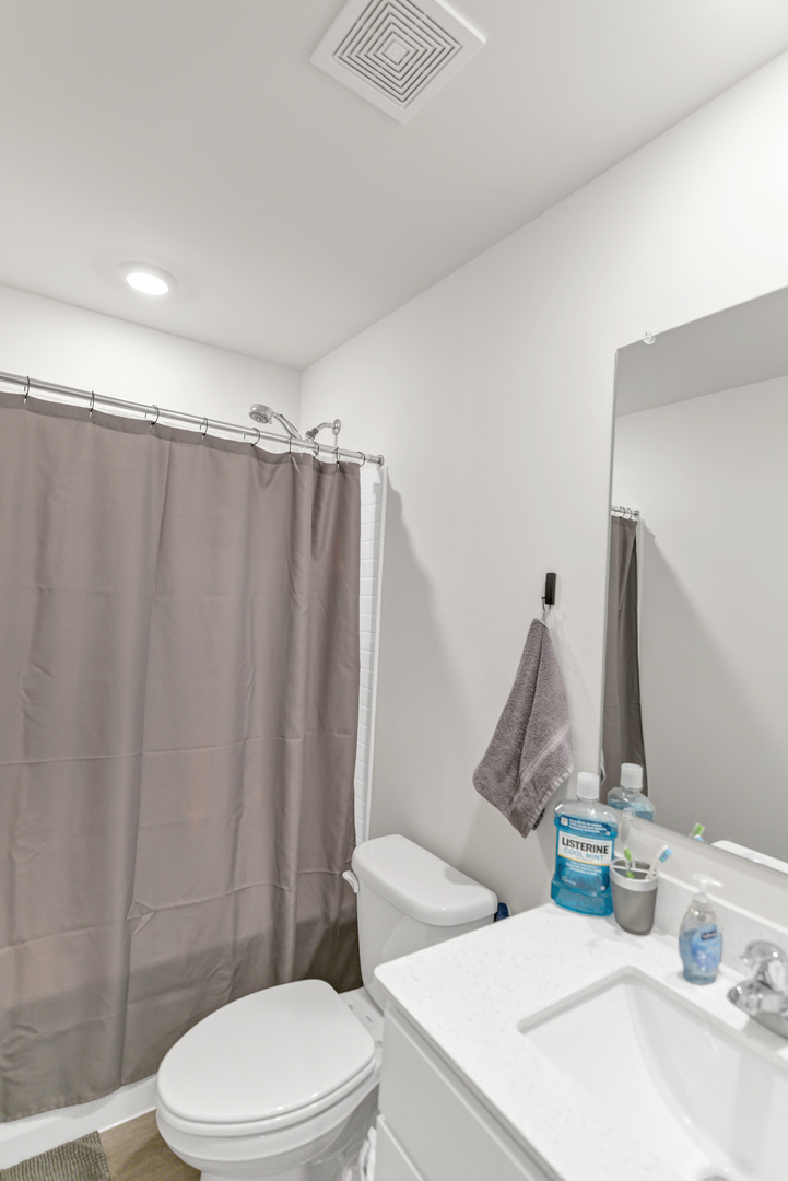 1464 Sequoia Way Hampshire, IL 60140 - Photo 27 of 31 a white toilet sitting next to a bathroom sink and a shower