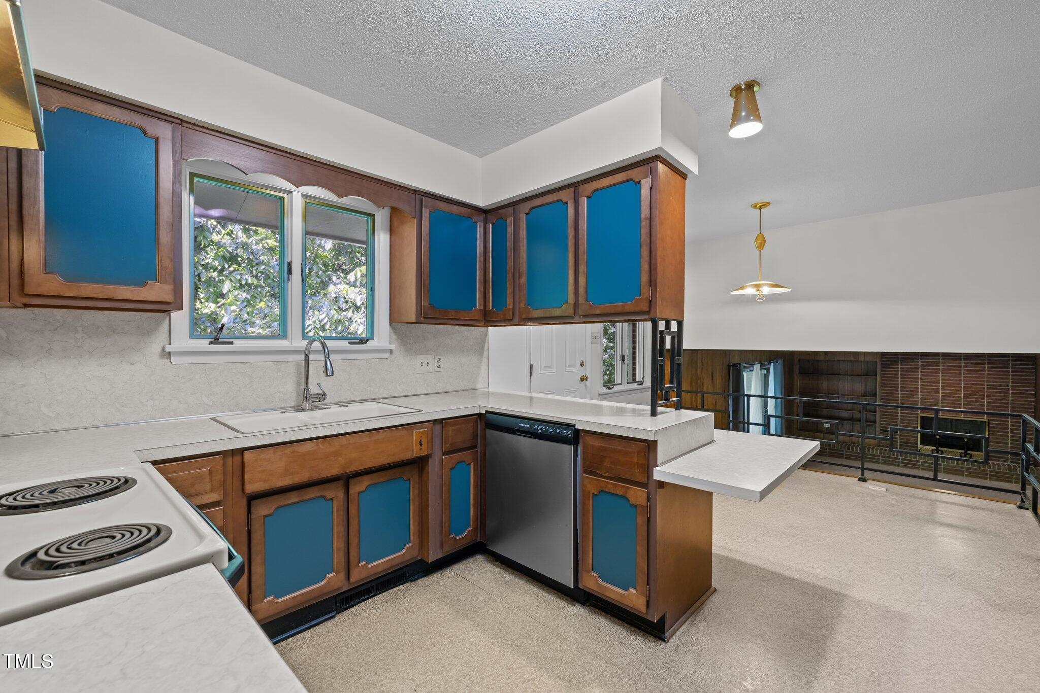 1024 Chalmers Street Durham, NC 27707 - Photo 11 of 41 a kitchen with a sink stove top oven and cabinets