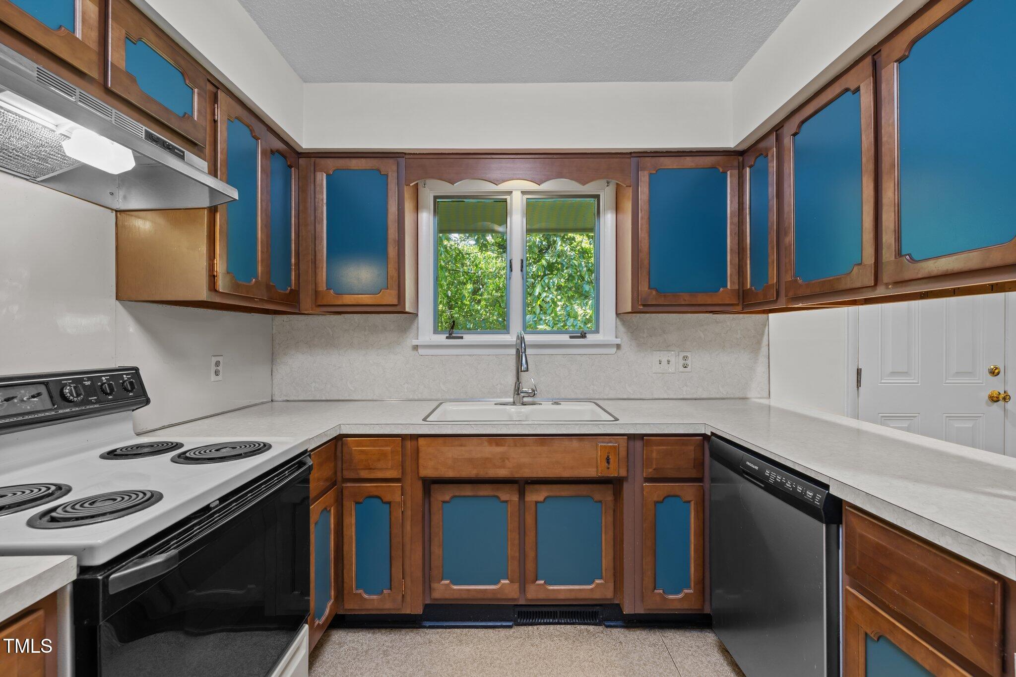 1024 Chalmers Street Durham, NC 27707 - Photo 12 of 41 a kitchen that has a sink and a stove